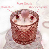 10 oz. Vanilla Rose Magick Candle adorned with a Rose Quartz Heart and Sprinkles to open the heart to the divine love of the Universe. It calms and soothes. Mini Rose Buds are a symbol of love. The raspberry-pink stones are Rhodochrosite which is a powerful kicker for love attraction!