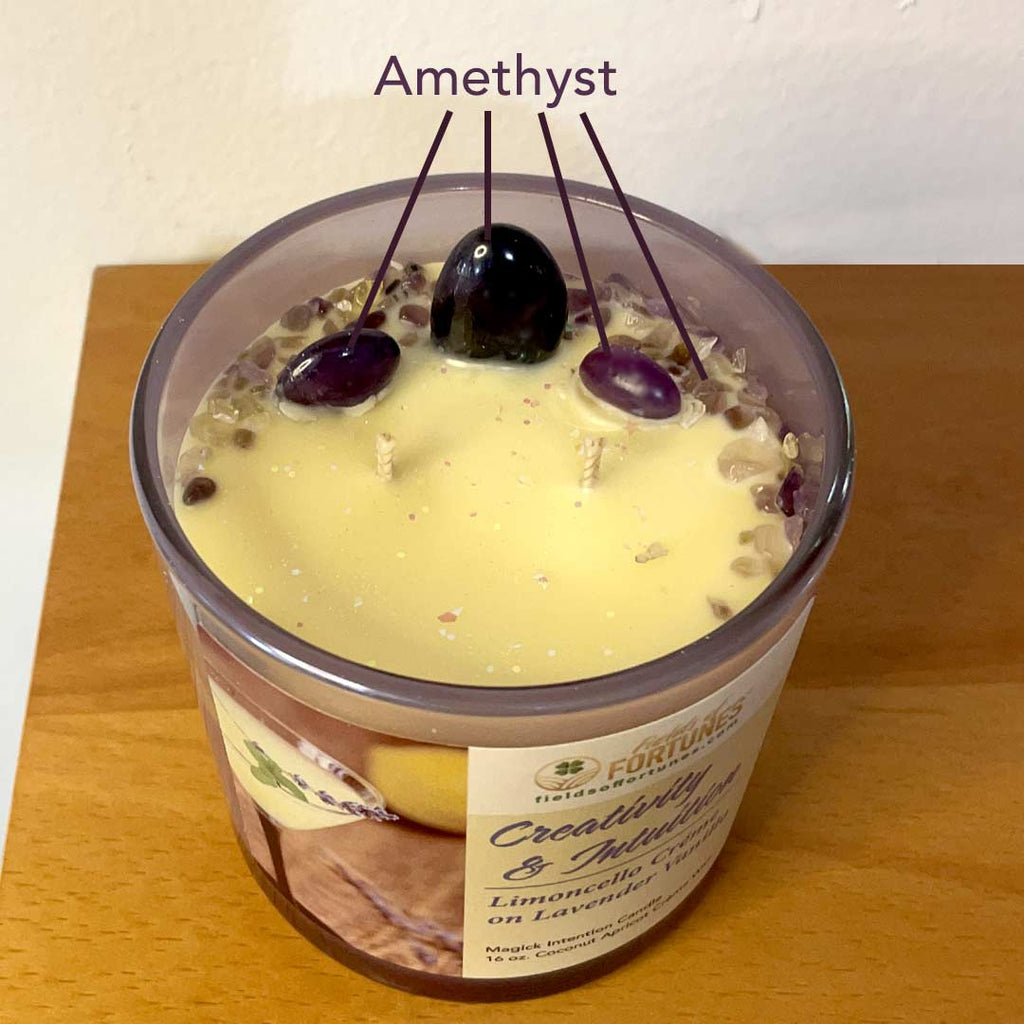 16 oz. Limoncello and Lavender  Vanilla  Intention Candle.  Two-layered candle in a iridescent container on a wooden surface. Three large amethyst stone with sprinkles of amethyst, two wicks.