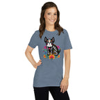 Woman wearing a heather indigo  t-shirt with a colorful dia de los meurtos dog design.