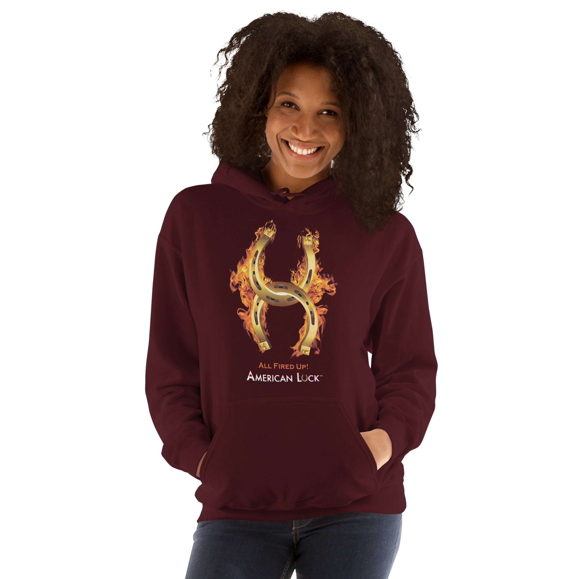 Person wearing a  maroon hoodie with a fiery golden horseshoe  design, All Fired Up! American Luck.