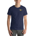 Person wearing a navy blue t-shirt with small gold Viking Spirit design.