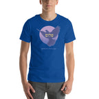 A person wearing true royal blue t-shirt with a dove in front of pink moon and Spread Shalom in english and gold hebrew letters.